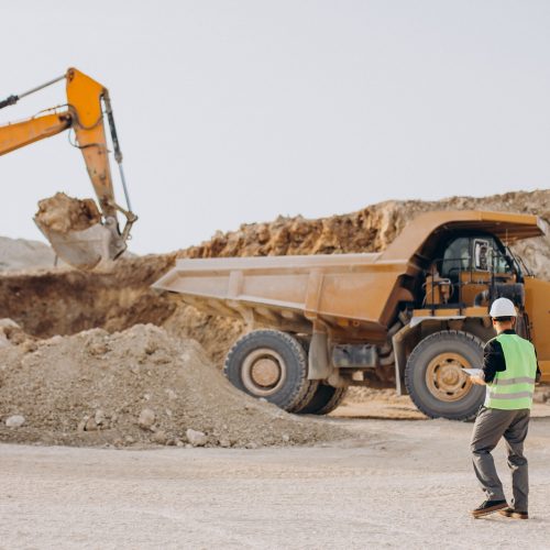 Male worker with bulldozer in sand quarry Male worker with bulldozer in sand quarry